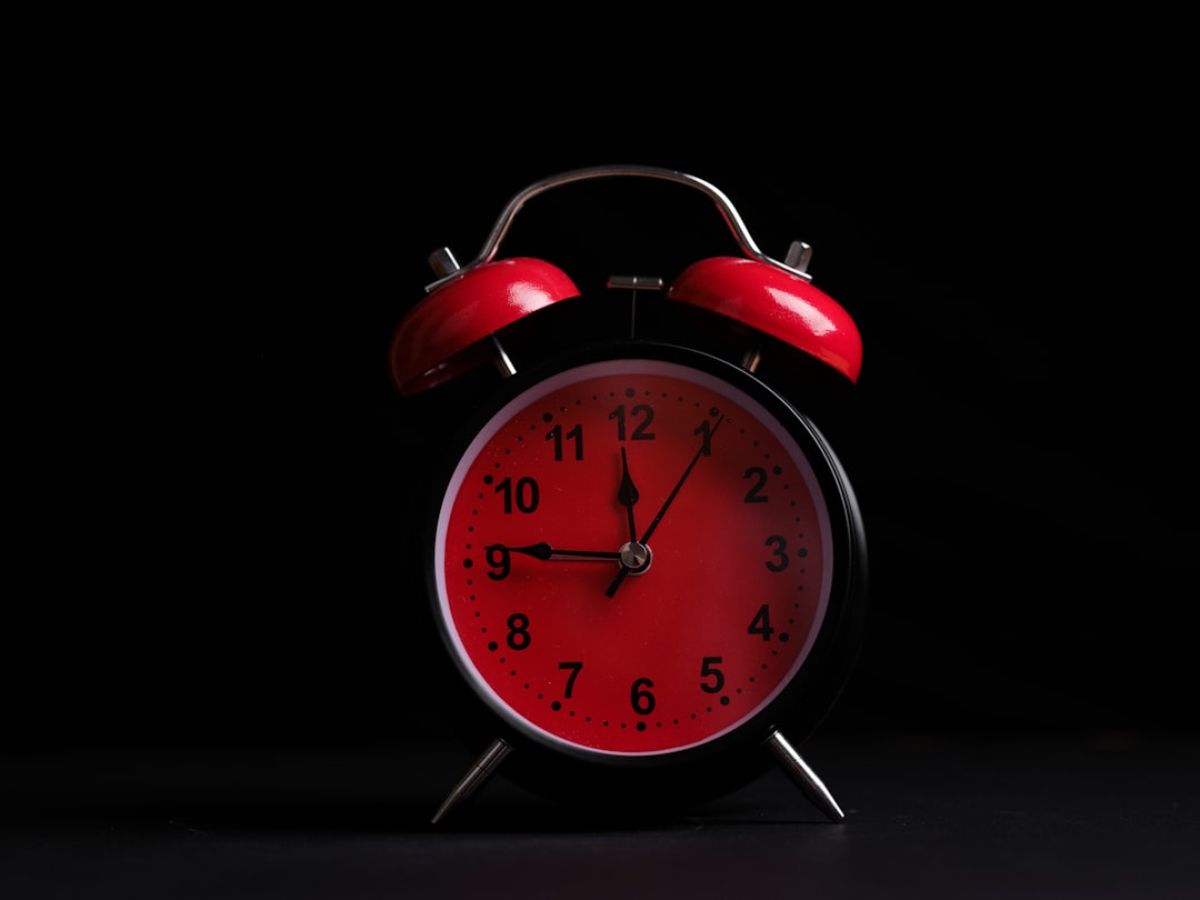 red alarm clock on a black background