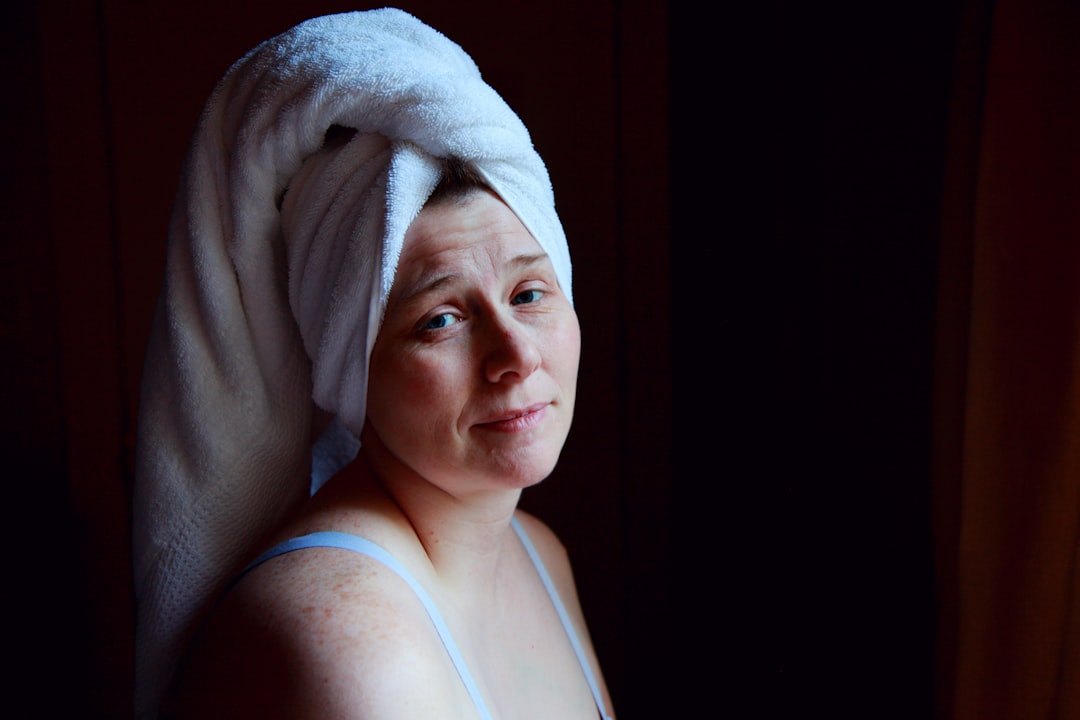 After taking a shower, Shane dries his hair. 