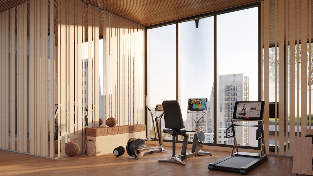 A stylish, modern urban gym with a city skyline view; featuring a warm wooden interior and a range of high-end fitness equipment