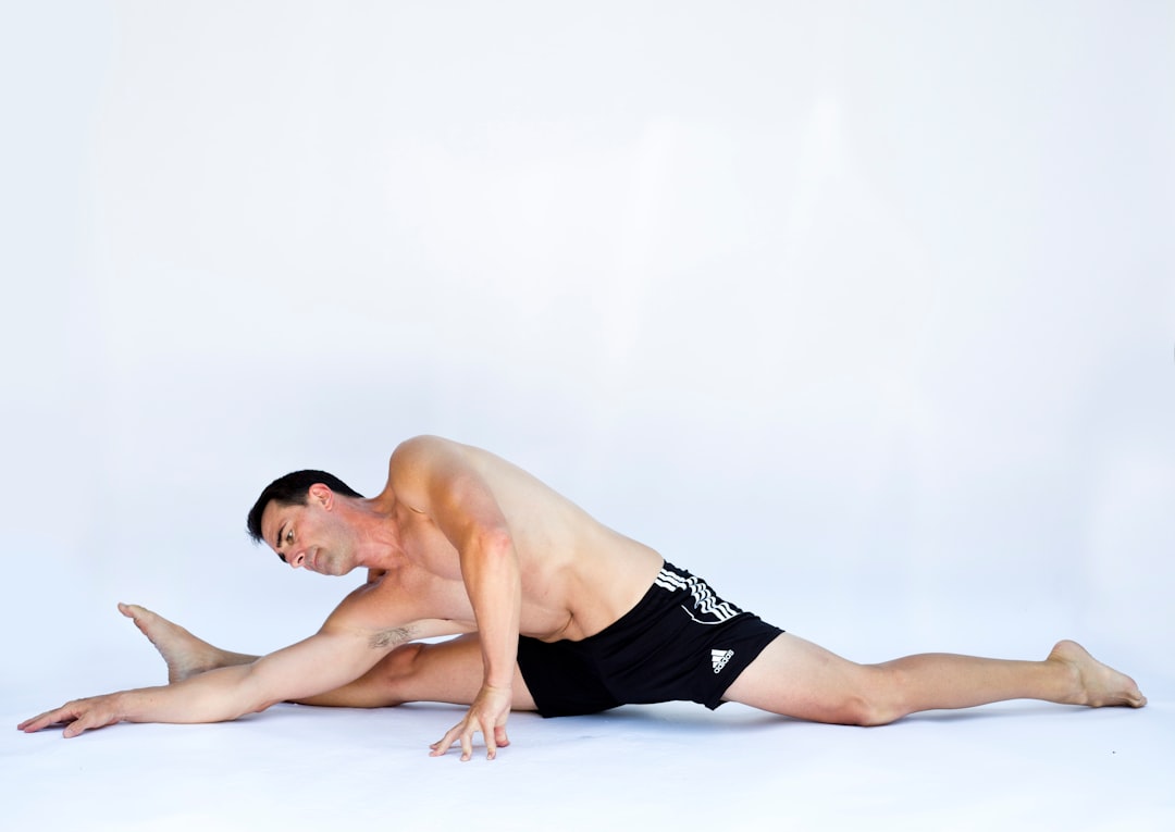 a man stretching and doing the splits